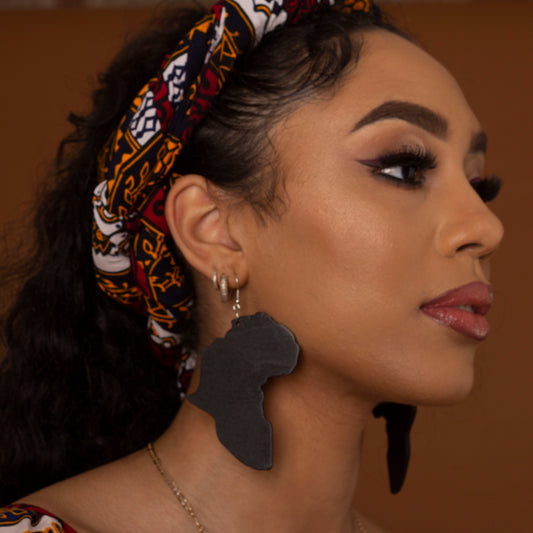 Black wooden earrings featuring the shape of the map of Africa